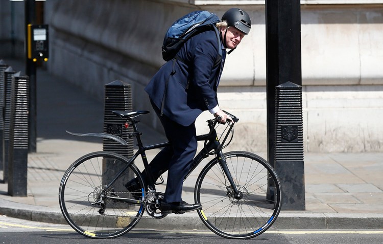 Boris Johnson rides his bike along Whitehall in London earlier this month. Instead of choosing a team player for the nation's top diplomatic post, Theresa May has chosen a politician who prides himself on being different.