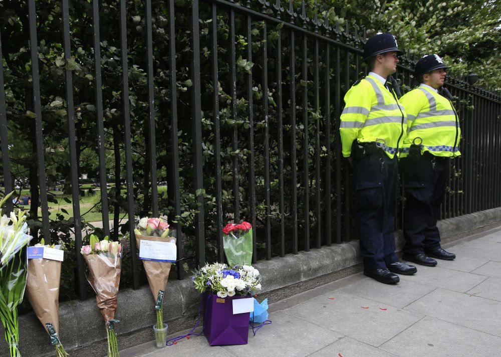 Floral tributes rest against railings Thursday near the scene of stabbings Wednesday night in Russell Square, London, that left an American woman from Florida dead and five others injured.