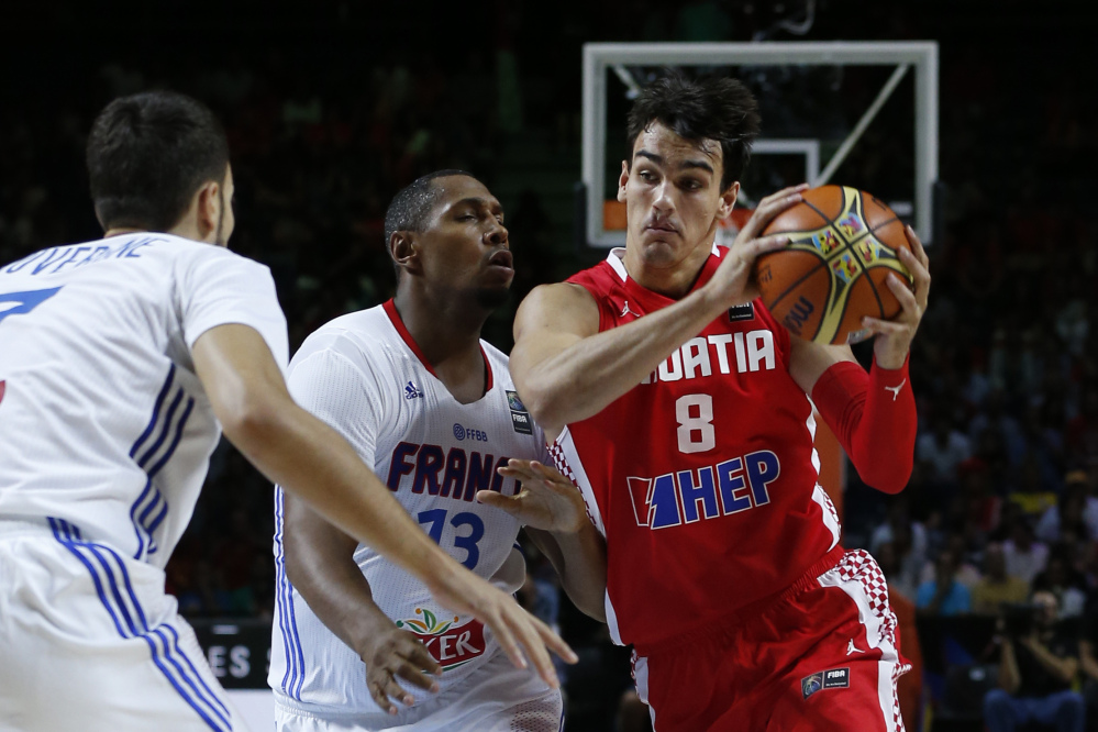 Croatia's Dario Saric, right, drives the ball against France's Boris Diaw, center, and Joffrey Lauvergne during a game in 2014. Saric is one of the players worth watching during the Olympics.