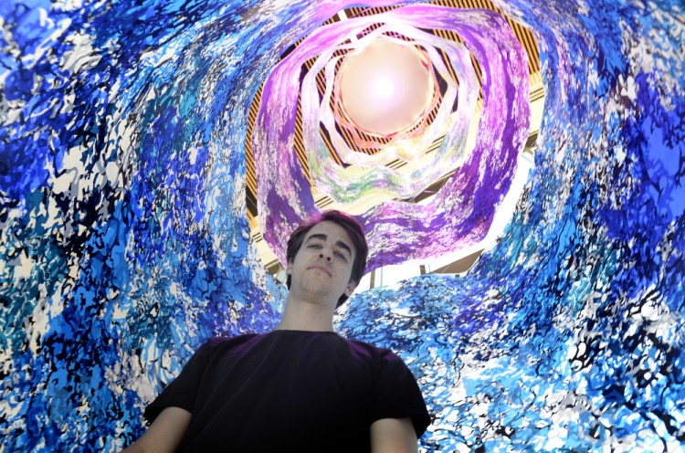 Carter Shappy inside his cylindrical "Colorcosm" at Bigelow Laboratory for Ocean Sciences in East Boothbay. The 20-foot-high print emulates an enclosure used by scientists in underwater research.