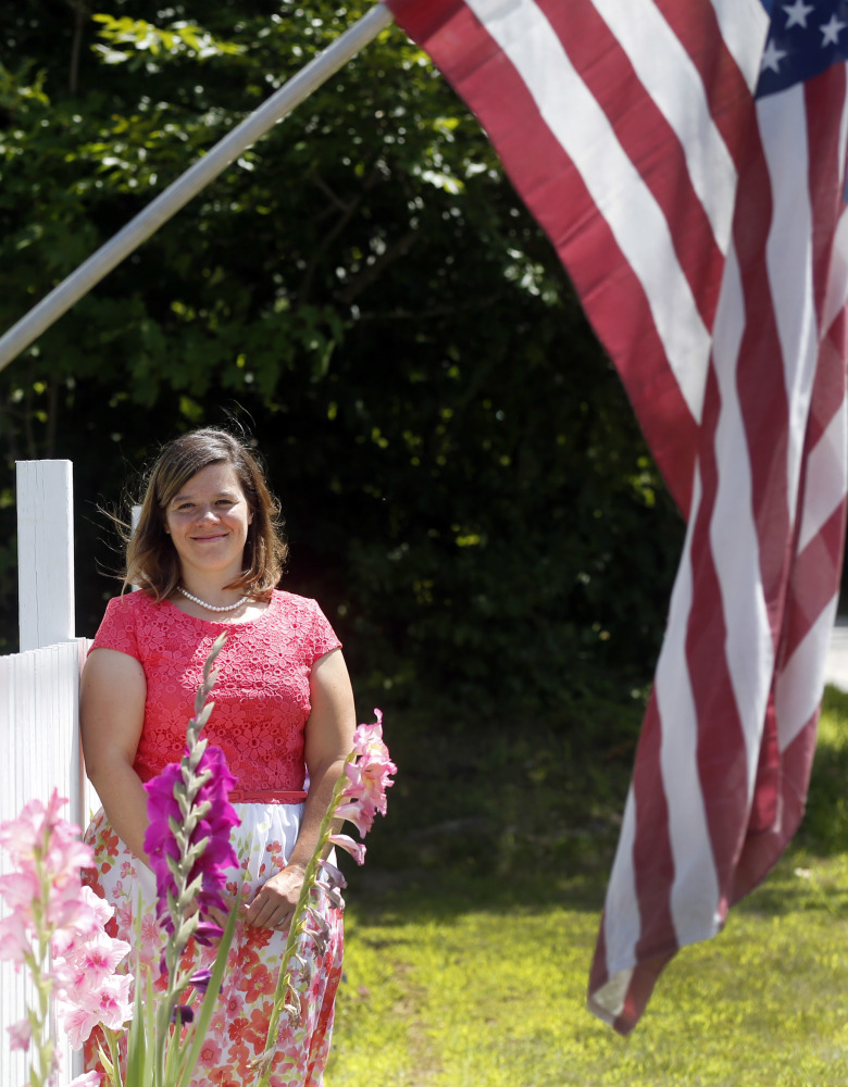 Aimee Fogg poses at her home in Gilford, N.H. Since 2010, she's collected stories about New Hampshire and Vermont men buried at the Henri-Chapelle American Cemetery.