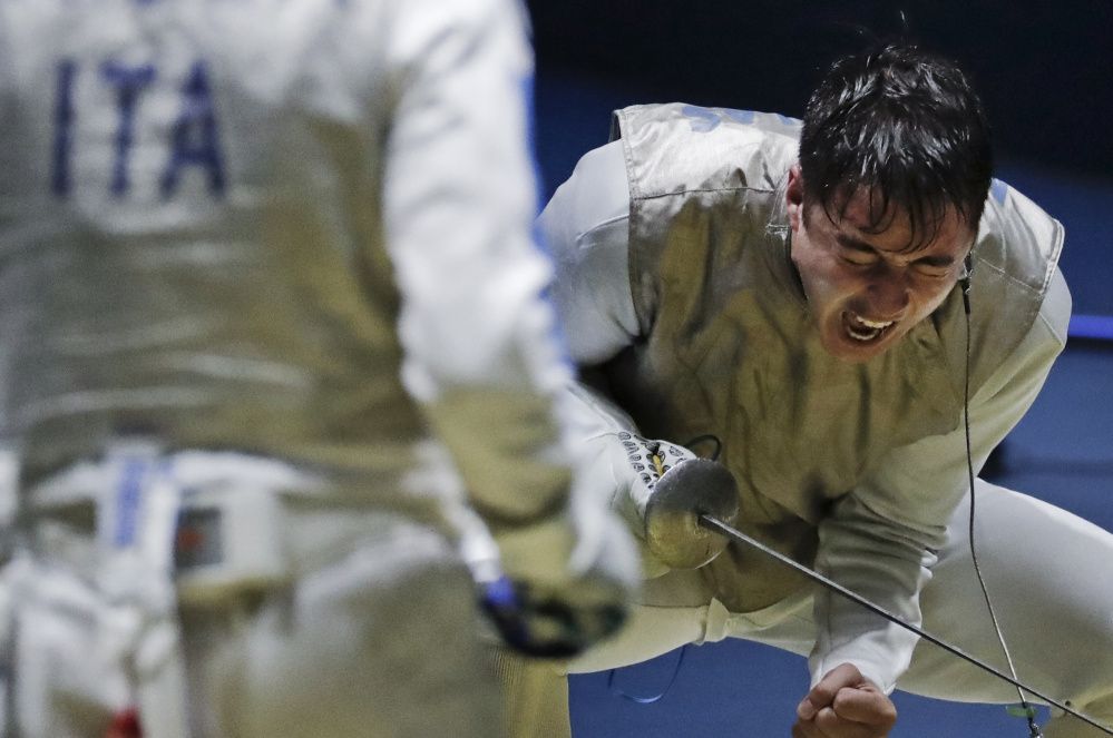 Alexander Massialas of the U.S. celebrates after beating Italy's Giorgio Avola in a foil fencing quarterfinal. Massialas later lost in the gold-medal match.
