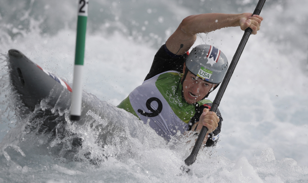 Michal Smolen of the United States steers through a gate during the kayak K1 men's heats. Smolen posted the 10th-best score and advanced to Wednesday's semifinals.