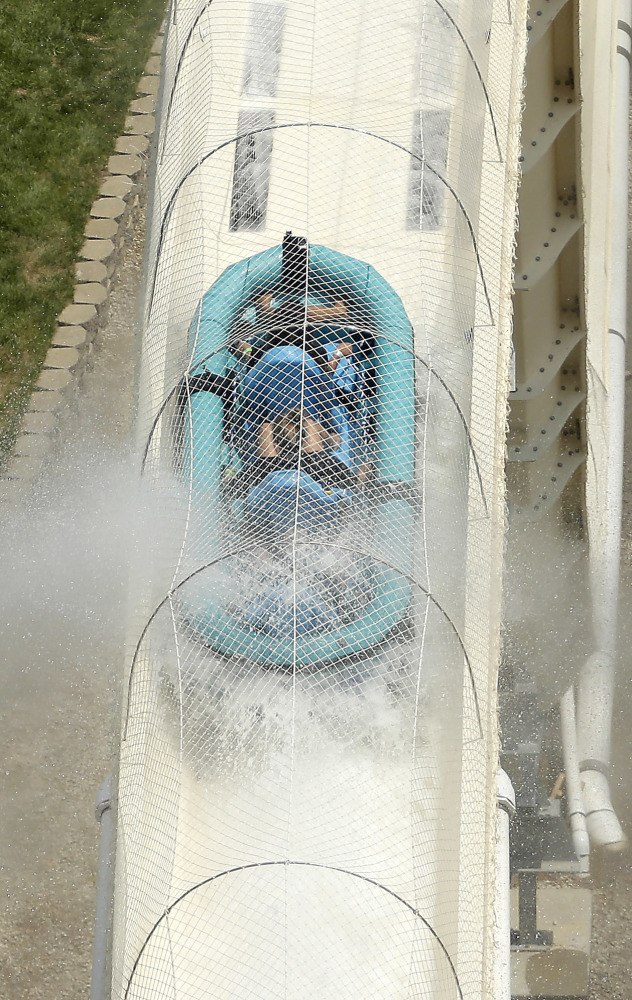 Riders propelled by jets of water go over a hump while riding a raft waterslide called "Verruckt" at Schlitterbahn Waterpark in Kansas City, Kan.