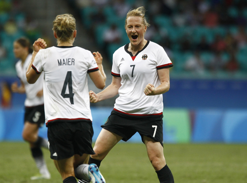 Germany's Melanie Behringer, right, celebrates her goal with teammate Leonie Maier during their quarterfinal match Friday against China. The goal proved to be the game winner and Germany advanced to the Olympic semifinals.