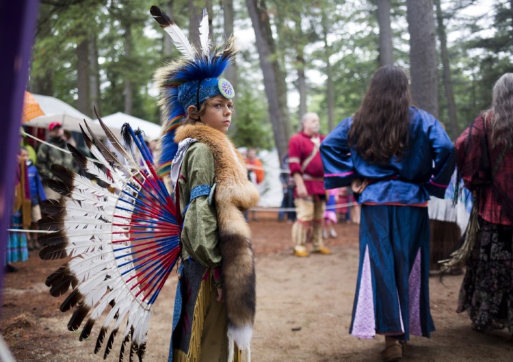 Robert Allen, 10, stands guard during the women's traditional dance at the Attean Family Pow Wow at Maine Wildlife Park on Saturday, August 13, 2016.