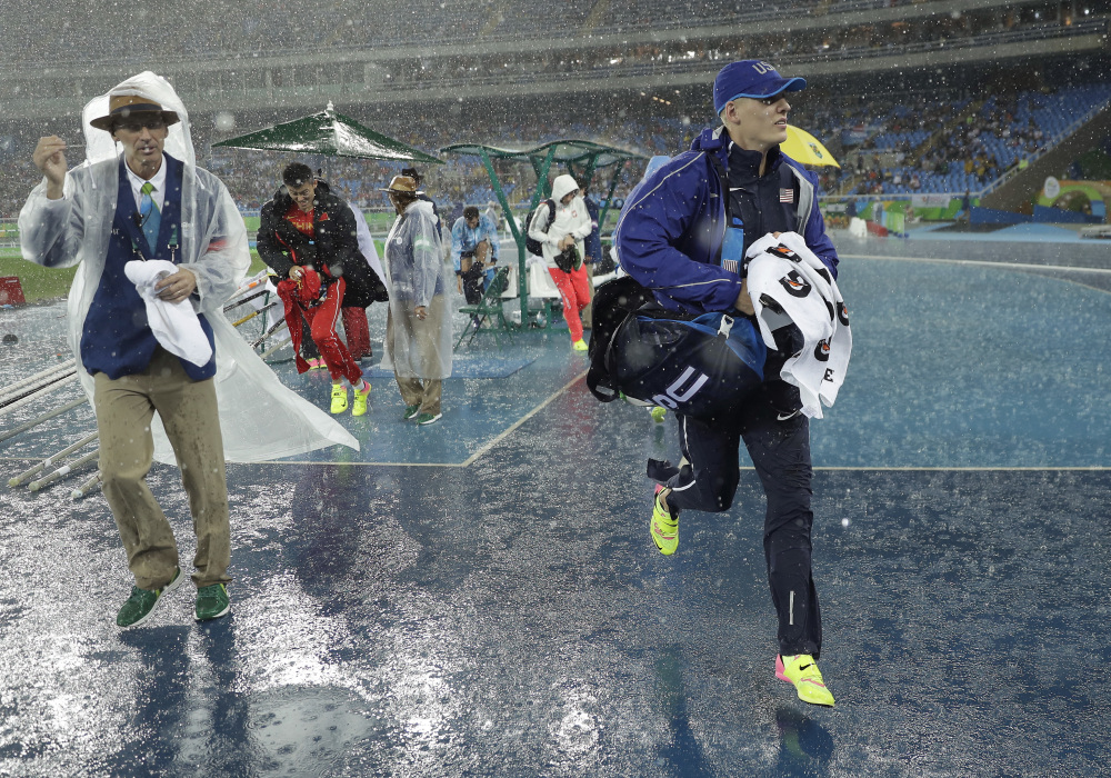 United States' Sam Kendricks leaves the field because of rain during the athletics competitions of the 2016 Summer Olympics at the Olympic stadium in Rio de Janeiro.
