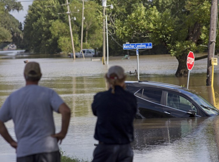 Residents survey the floodwater near Prairieville, La., Tuesday.  Gov. John Bel Edwards told a news briefing, "I don't know that we have a good handle on the number of people who are missing."