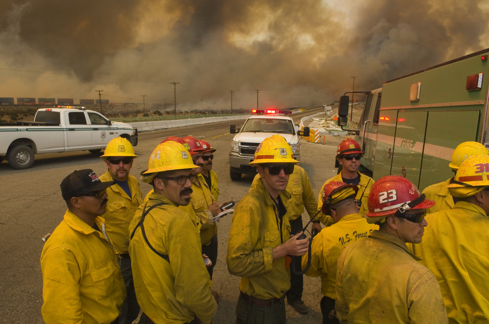 A U.S. Forest Service crew looks for routes to aid in battling a wildfire near Highway 138 and Interstate 15 in California.