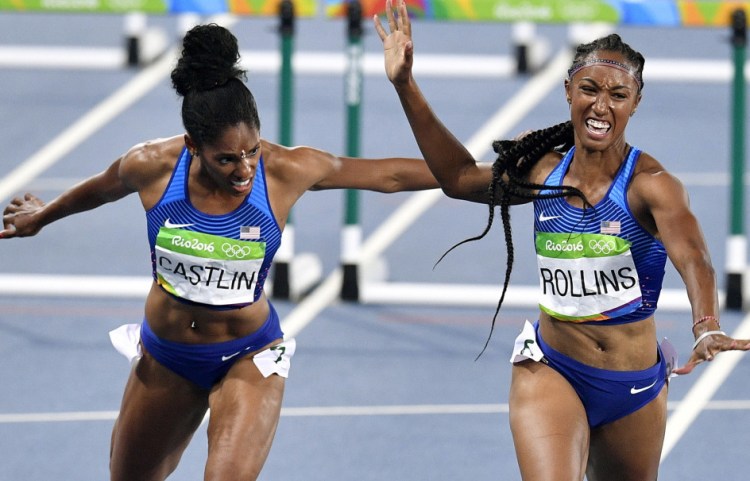 Brianna Rollins of the United States, right, wins the gold medal in the women's 100-meter hurdles Wednesday night. Kristi Castlin of the U.S., left, was third as the Americans swept the event.