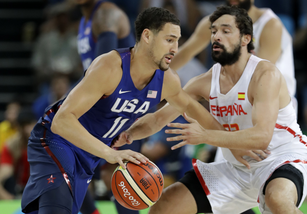 Klay Thompson of the U.S. drives past Spain's Sergio Llull during Friday's men's basketball semifinal, won by the U.S., 82-76. The U.S. vies for its third consecutive Olympic gold medal Sunday against Serbia.