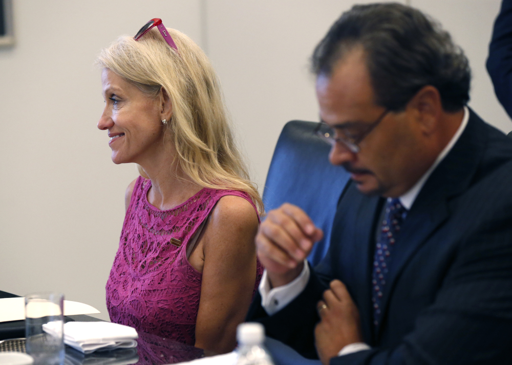 Kellyanne Conway, left, campaign manager for Republican presidential candidate Donald Trump, attends his Hispanic advisory roundtable meeting in New York, Saturday, Aug. 20, 2016. At right is Rick Figueroa, first vice president for FINC Firm of Houston. (AP Photo/Gerald Herbert)