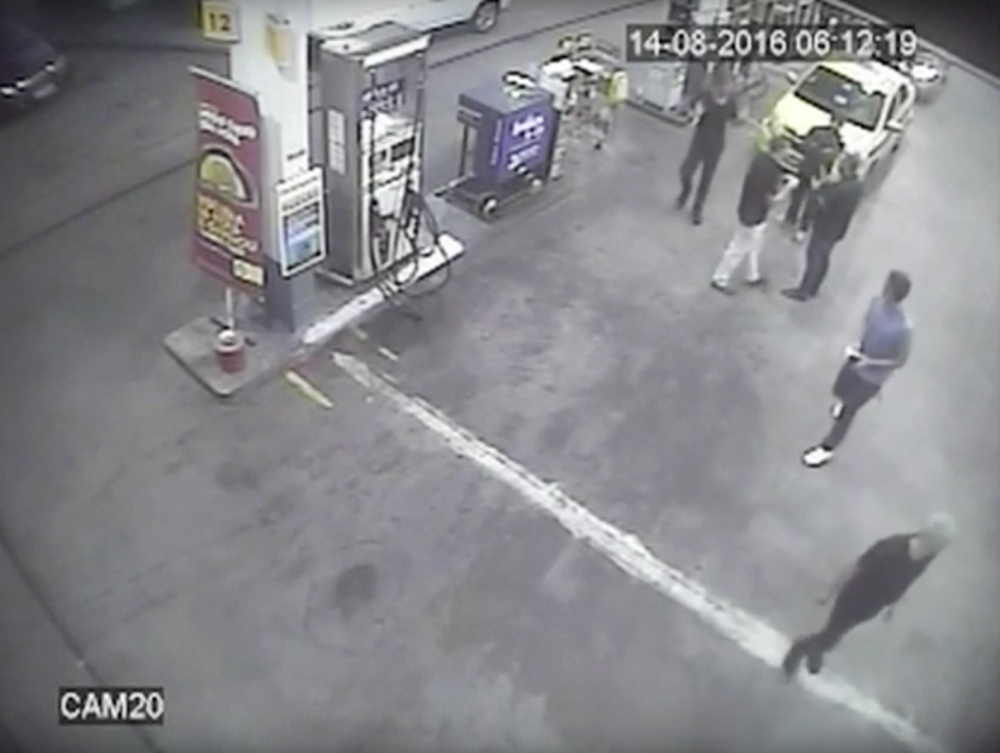 In this Sunday, Aug. 14, 2016 frame from surveillance video released by Brazil Police, swimmers from the United States Olympic team appear with Ryan Lochte, right, at a gas station during the 2016 Summer Olympics in Rio de Janeiro, Brazil. A top Brazil police official said the swimmers damaged property at the gas station.
