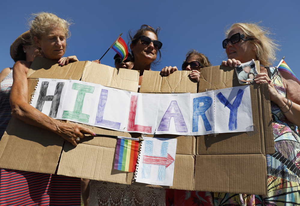The four "Smith Sisters" from New York state hold a sign they made supporting Democratic presidential candidate Hillary Clinton outside the gate of Provincetown Municipal Airport in Provincetown, Mass.