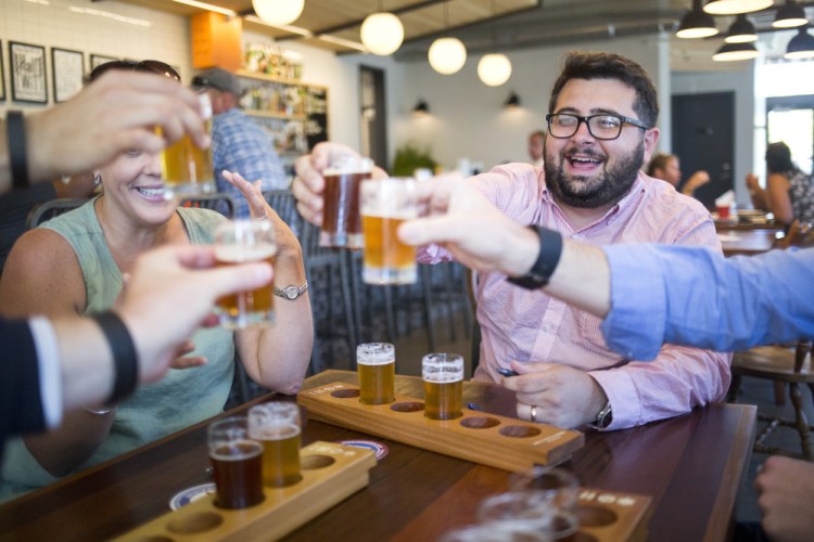 At Foulmouthed Brewing, Adam Pontius and others mark the end of a demonstration of ranked-choice beer tastings to be put on by the Committee for Ranked Choice Voting.