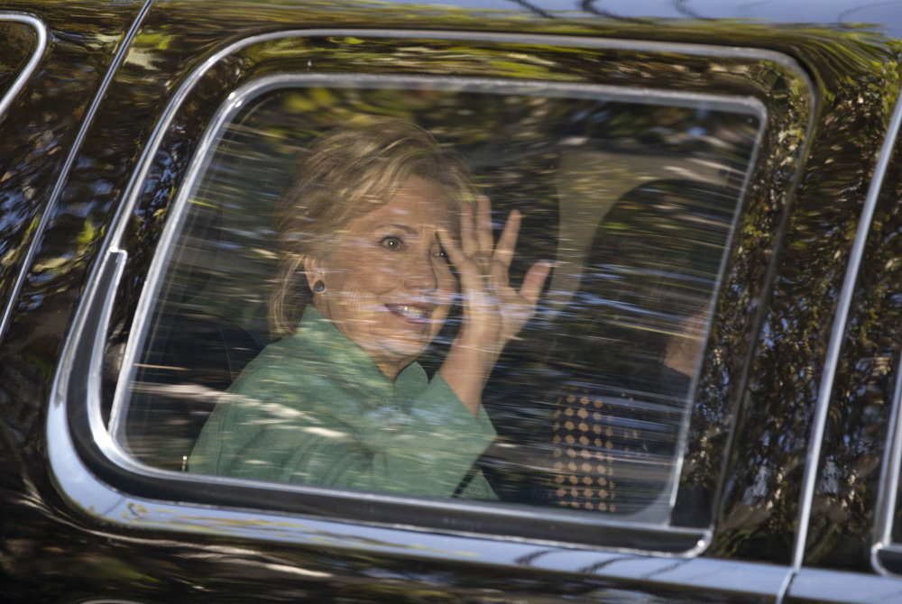 Hillary Clinton waves from her vehicle as she arrives for a fundraiser at the home of Justin Timberlake and Jessica Biel in Los Angeles on Tuesday.