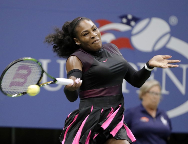 Serena Williams returns a shot from Ekaterina Makarova during a first-round win at the U.S. Open on Tuesday in New York. Williams is after a record-breaking 23rd major title.