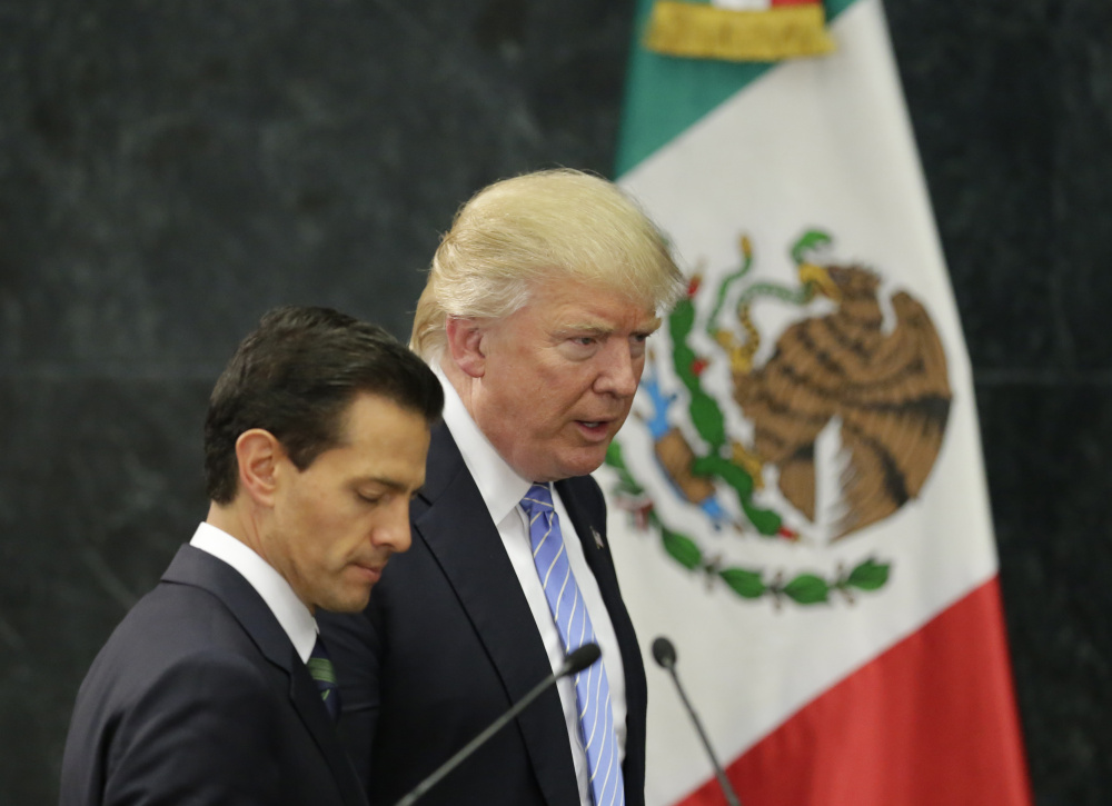 Donald Trump and Mexico's President Enrique Pena Nieto arrive for their press conference Wednesday at the Los Pinos residence in Mexico City.