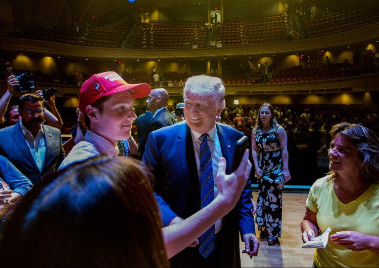 Connor Mullen, a South Portland High School student, takes a "selfie" with Donald Trump at Merrill Auditorium.