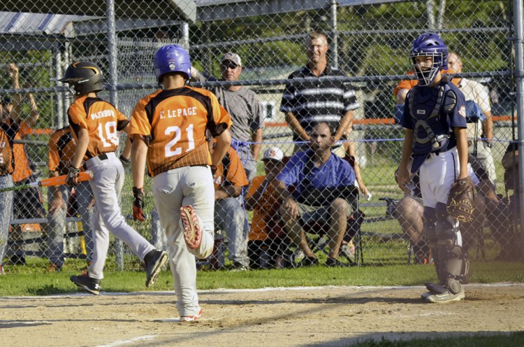 Oxford, Connecticut's catcher could only watch as Skowhegan baserunners Peyson Washburn and Collin LePage score in the third inning during Tuesday's elimination game in the Cal Ripken 11-Under baseball tournament in Skowhegan. Skowhegan stayed alive, winning 12-5.