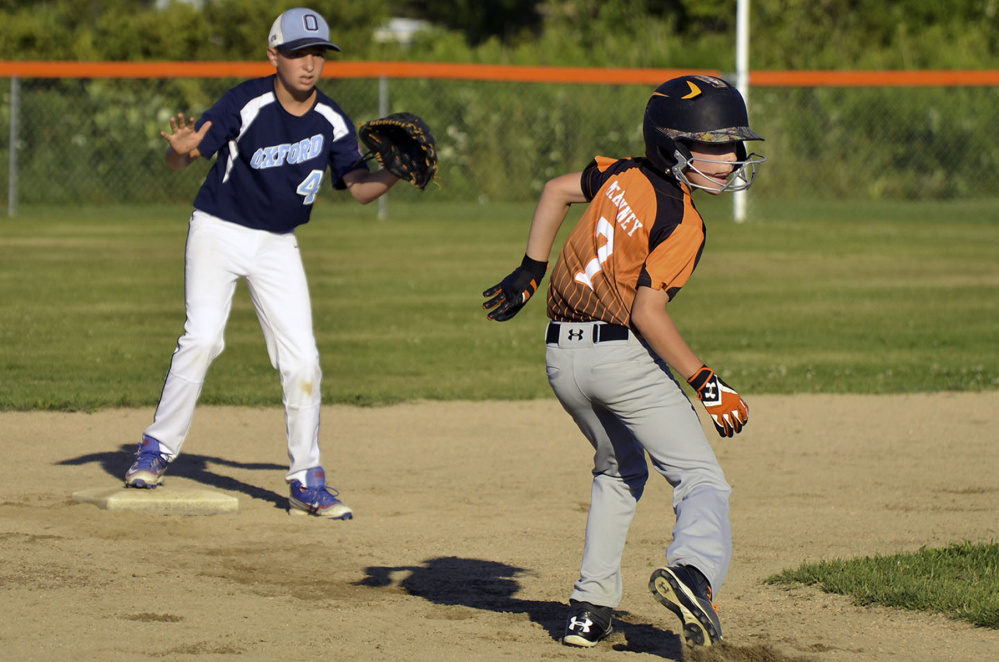 Skowhegan's Patrick McKenney is safe after being caught in a pickle during Tuesday's Cal Ripken 11-Under New England tournament game against Oxford, Connecticut, Tuesday. Skowhegan won, 12-5.