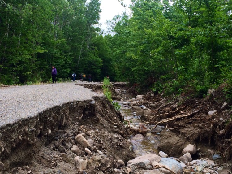 Heavy damage to No Road, a gravel road that provides access for about 30 property owners in the unorganized territory of Somerset County, attracted several spectators who were surveying the damage July 2.