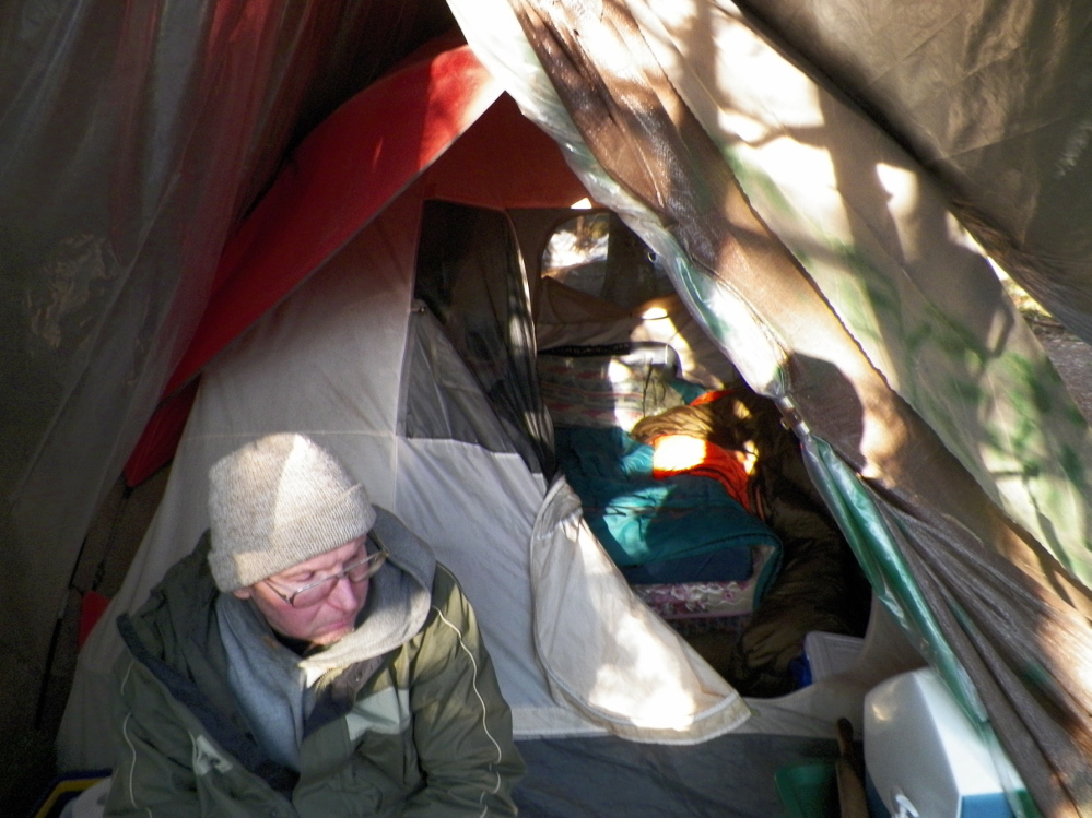 Christopher Knight sits at his camp in April 2013 in the central Maine woods after he led authorities to his campsite.