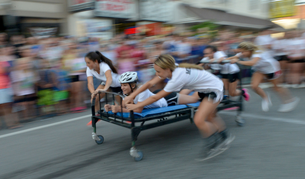 A bed race team competes in the annual bed races Thursday at Moonlight Madness in downtown Skowhegan.