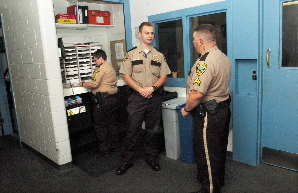 Thomas College student and Kennebec County Correctional Facility intern Tyler LeClair, center, speaks with Cpl. Sean Cipriano with officer Myra Gagnon behind him at the Augusta jail. LeClair is studying criminal justice and has put some of his "empathy-based" education to the test in his summer job.