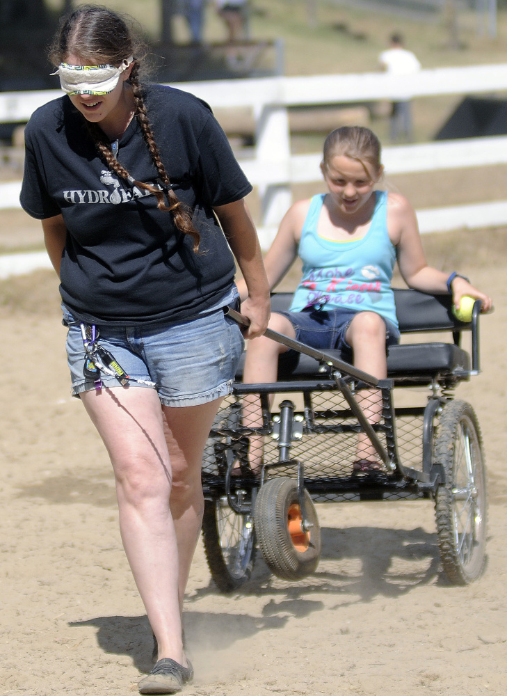 Jennifer Morrison follows instructions from her daughter, Chianna, 10, while competing in the Back Seat Driver Contest at the Monmouth Fair on Sunday.
