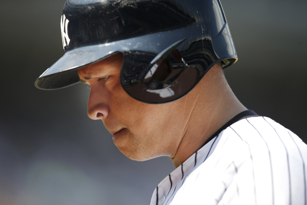 In this July 19, 2015 photo, New York Yankees designated hitter Alex Rodriguez returns to the dugout after popping out to third in a game against the Mariners at Yankee Stadium, in New York.