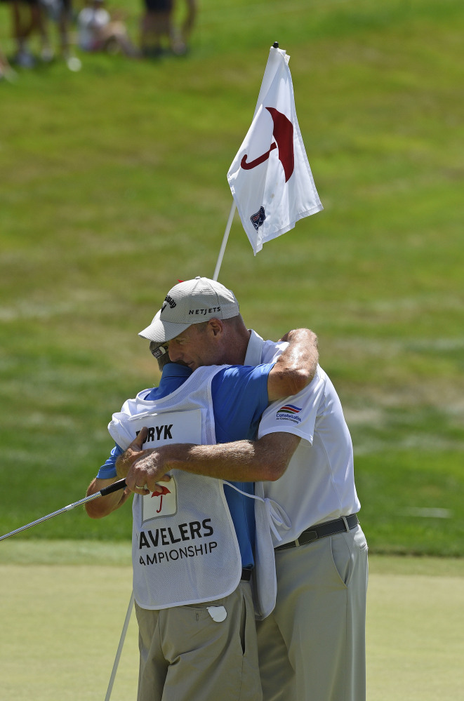 Jim Furyk celebrates with his caddy Mike 'Fluff' Cowan after shooting a PGA record 58 during the final round of the Travelers Championship in Cromwell, Connecitcut on Sunday.