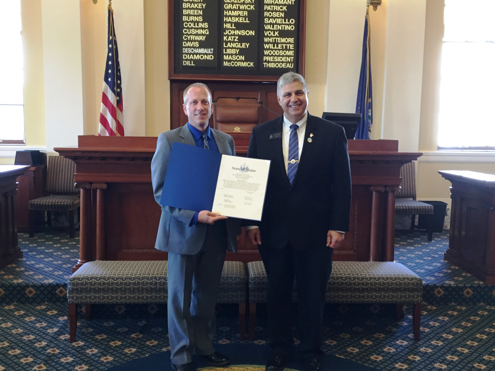 Sen. Scott Cyrway, R-Benton, right, presented a legislative sentiment July 15 to Craig Johnson, left, of Benton, honoring Johnson's retirement after 28 years in law enforcement. Johnson most recently served as the Chief of Police for the Clinton Police Department for six years. He began his career with the Somerset County Sheriff's Department and has also worked for the police departments of Damariscotta and Newport.