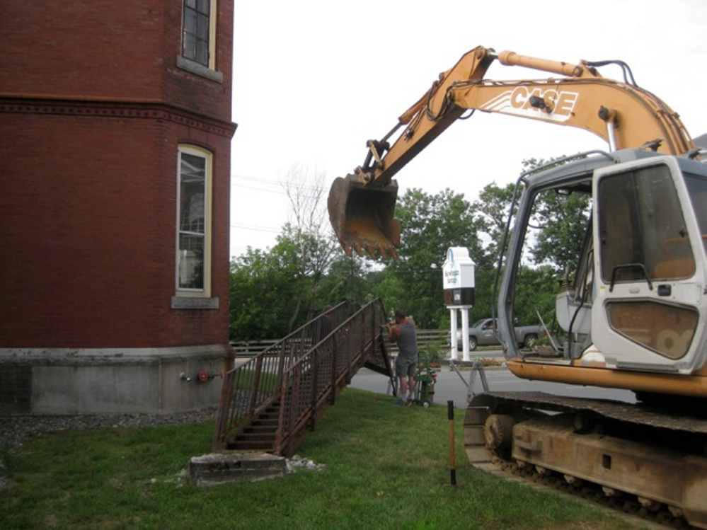 The old fire escape at the Skowhegan Free Public Library comes down to make way for construction of the elevator addition.