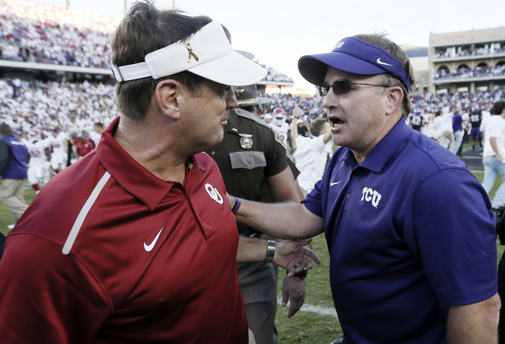 AP photo 
 In this Oct. 4, 2014, file photo, Oklahoma head coach Bob Stoops, left, and TCU head coach Gary Patterson meet after a game at Amon G. Carter Stadium in Fort Worth, Texas.