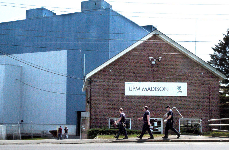 Workers carry tools into the Madison Paper Industries mill in Madison on May 23, two days after the mill ended production.