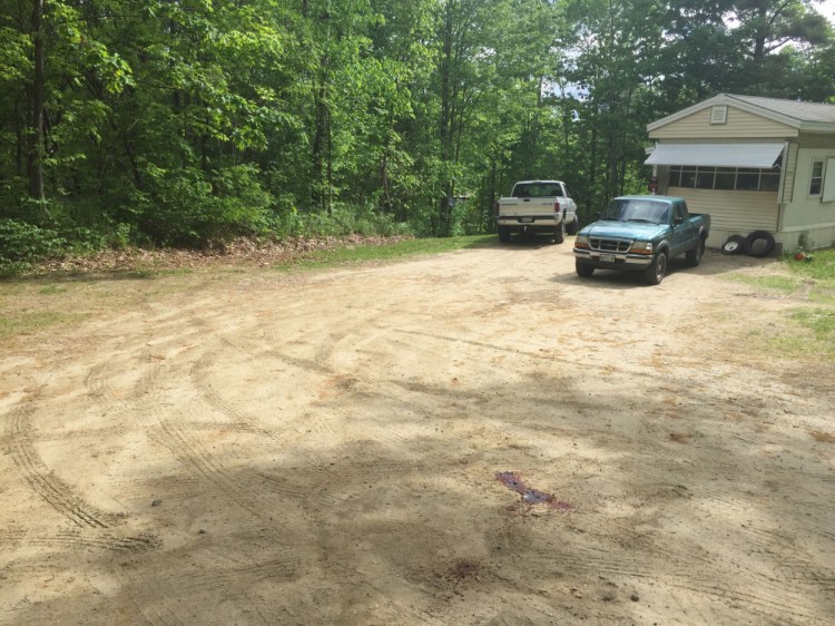 Blood pools on June 1 in the driveway at 259 Weld Road in Wilton, where police were investigating the shooting death that day of Michael Reis, of New Sharon. Timothy Danforth, a resident of the home owned by his father, was arrested Thursday, charged in Reis' slaying.