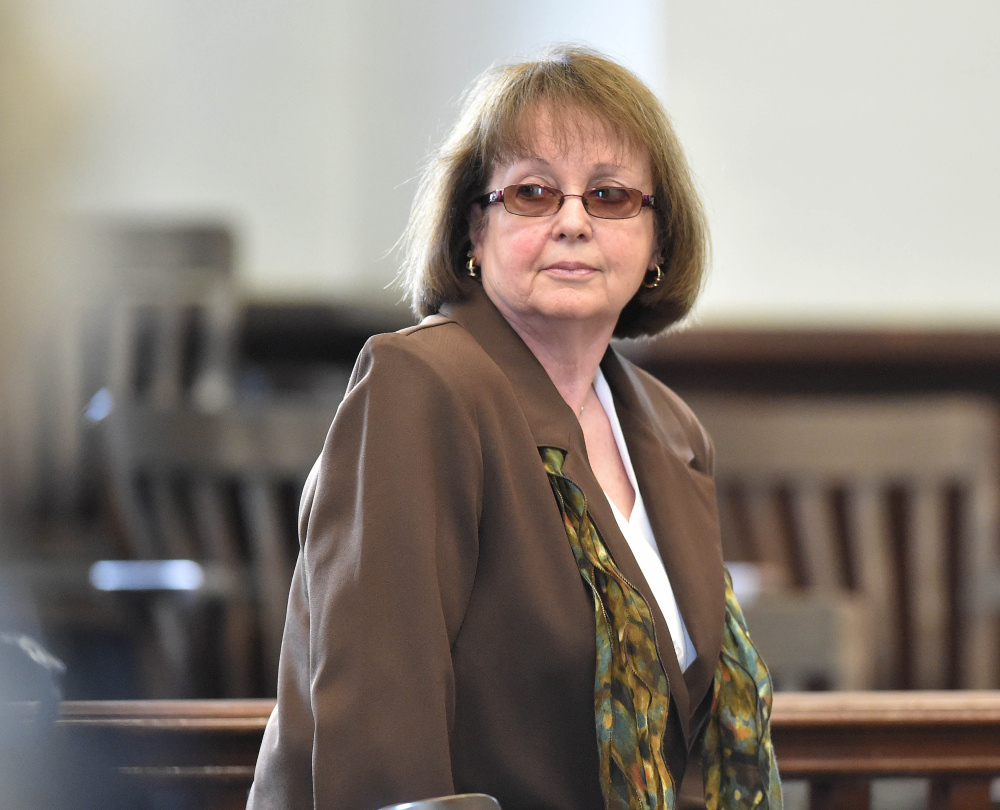 Claudia Viles stands as the jury leaves the court room to deliberate on the 13 charges against her at Somerset County Superior Court in Skowhegan on June 22. Anson's excise tax collections, which directly fund the town's highway department budget, have soared in the year since she resigned as the tax collector and the property tax rate has gone down.