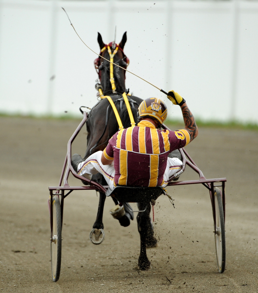 Ron Cushing celebrates after winning the 2014 Walter H. Hight Memorial race with Achilles Blue Chip at the Skowhegan State Fair.