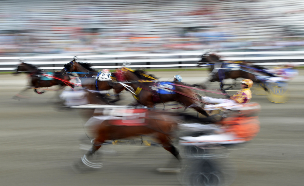 Harness racers leave the gate for the annual Walter H. Hight Memorial Pace at the Skowhegan Fair Grounds in Skowhegan on Saturday.