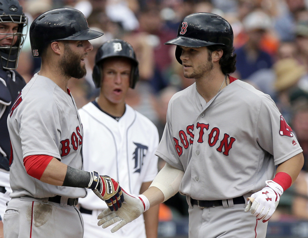 Boston's Andrew Benintendi, right, is congratulated by Dustin Pedroia after hitting a two-run home run against the Detroit Tigers during the seventh inning Sunday in Detroit.