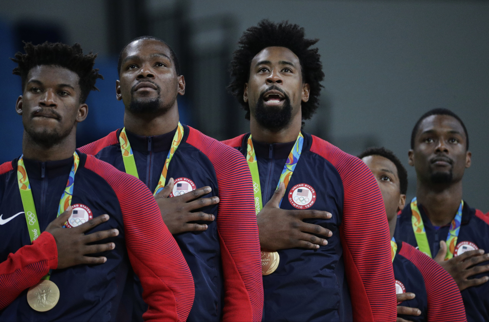 Members of the United States' basketball team stand for the national anthem after accepting their gold medals at the the 2016 Summer Olympics on Sunday in Rio de Janeiro, Brazil.