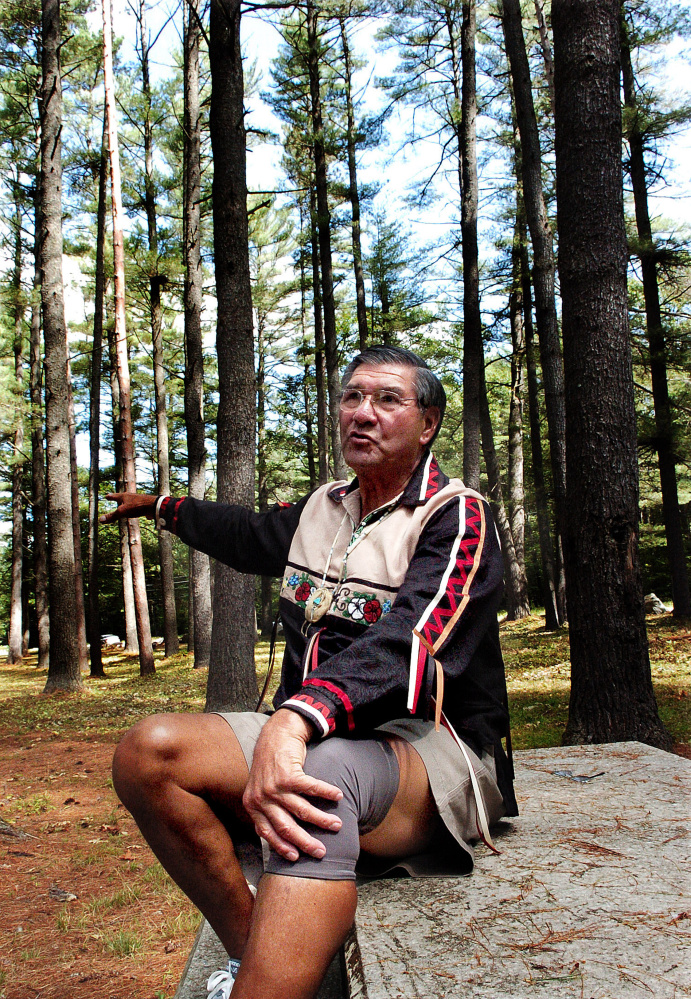 Penobscot tribe elder Butch Phillips speaks prior to a ceremony honoring ancestors on Sunday in The Pines area off the Father Rasle Road in Madison where native Americans were massacred in the 1724.