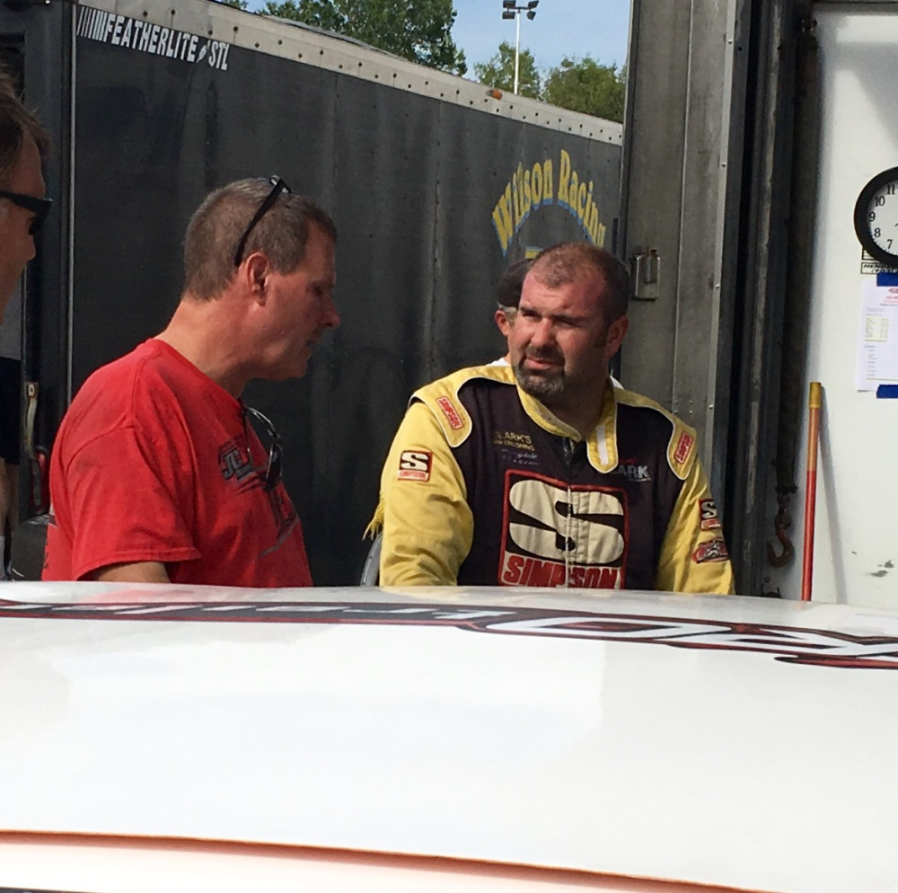 Johnny Clark, of Hallowell, right, talks about his car's performance with Joel Tozier during a practice session for the Pro All Stars Series race at Oxford Plains Speedway in on Aug. 1. The six-time series champion seeks his first Oxford 250 win this Sunday.