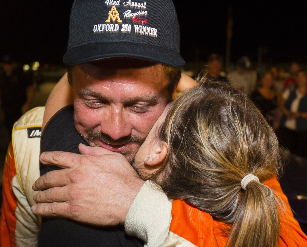 Glen Luce, of Turner, receives a congratulatory hug at the finish line after winning the Oxford 250 at Oxford Plains Speedway last year.