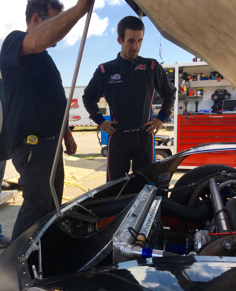 Fort Kent native Austin Theriault, right, looks over his car during a break in a Oxford 250 practice on Friday afternoon in Oxford. Theriault has two career podium finishes in the 250.
