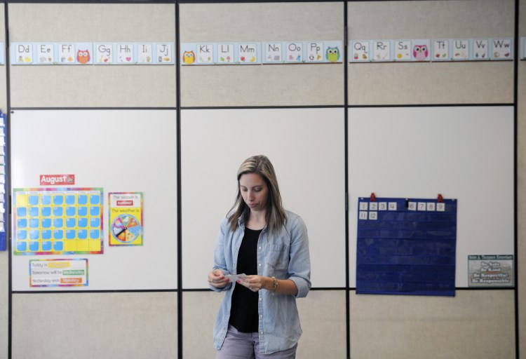 Samantha Jordan arranges a mathematics display in her classroom last week at Helen Thompson School in West Gardiner. In her first classroom and teaching first grade, Jordan's first day of school is Wednesday.