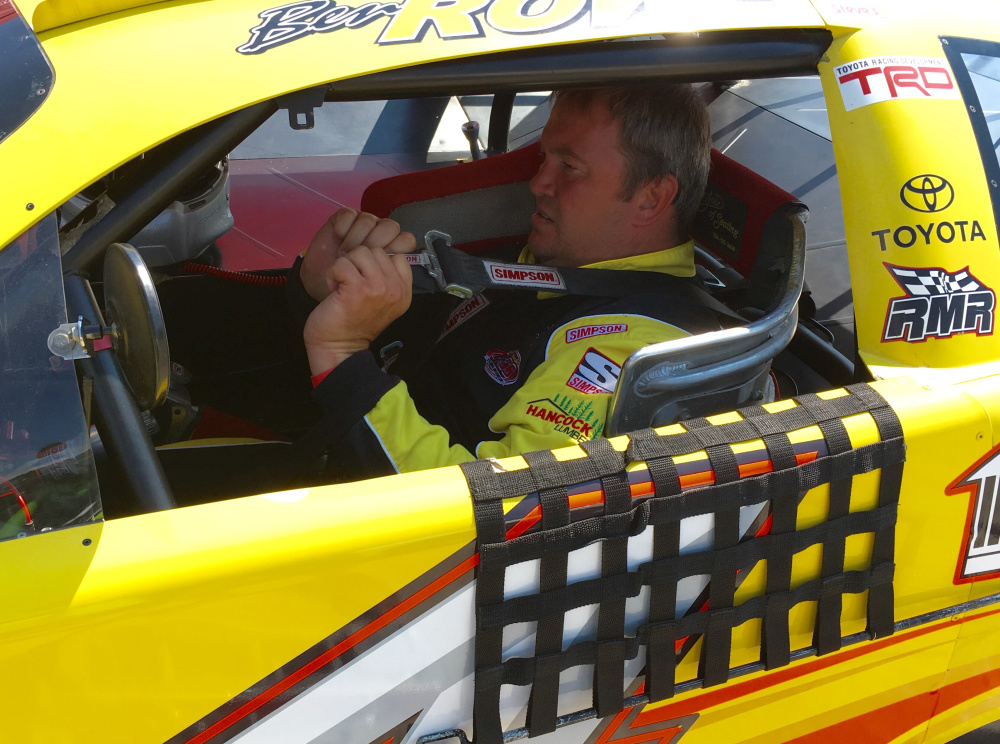 Two-time Oxford 250 winner Ben Rowe of Turner buckles into his race car for Oxford 250 practice on Friday at Oxford Plains Speedway.