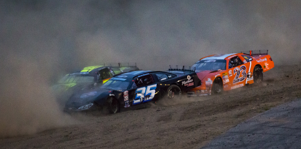 Cars kick up dust during a minor crash involving five cars during the Oxford 250. From left: Reid Lanpher, Derek Ramstrom and David Farrington.