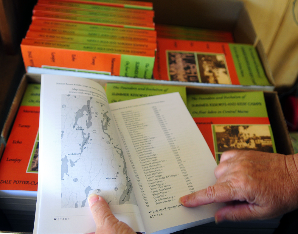 Dale Potter-Clark talks about the map and camps in the front of her recently published book Wednesday at her Vassalboro home.